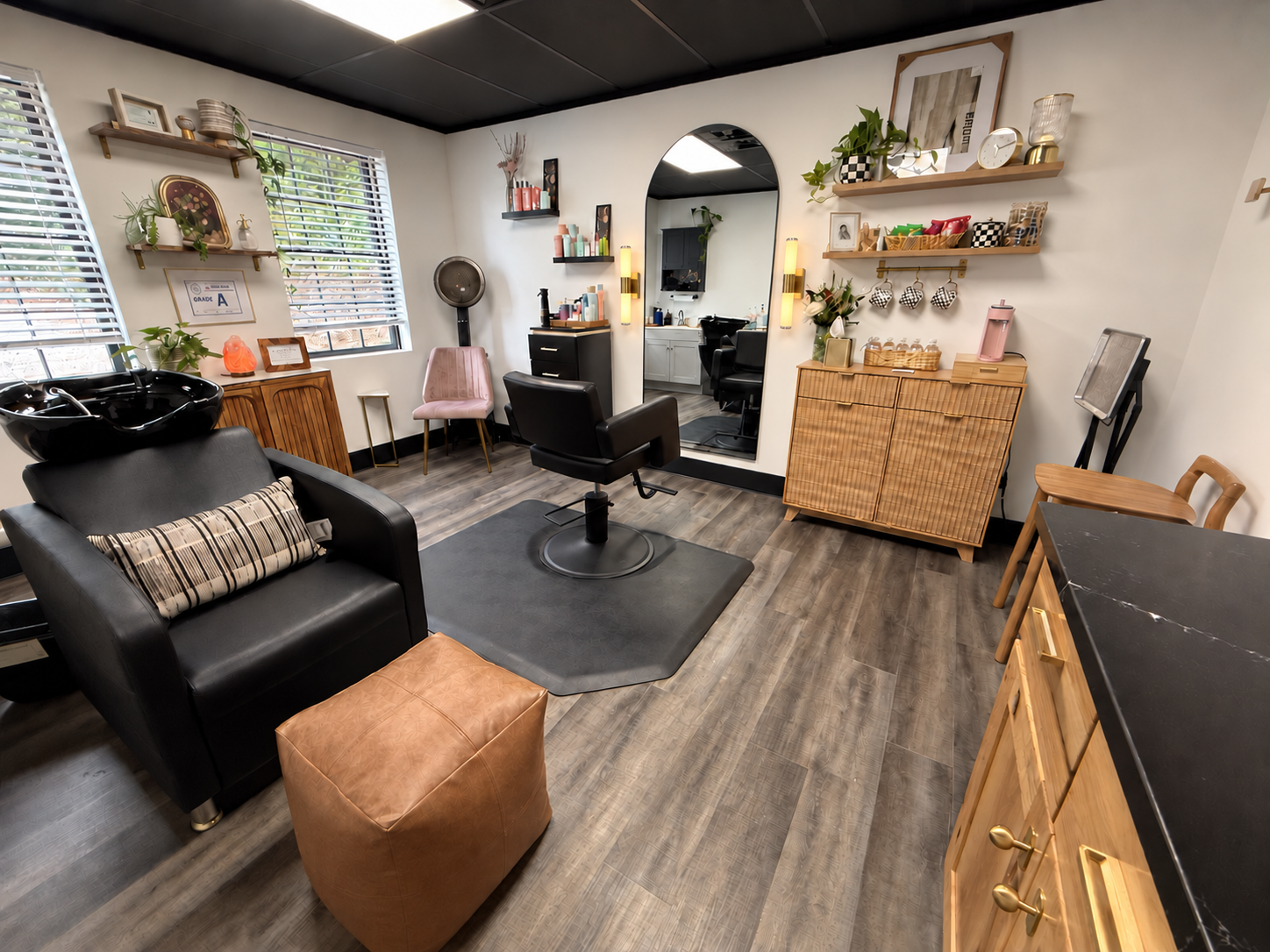 Sage & Arrow Salon private suite at Trade Street Studios with gold sconces beside the mirror